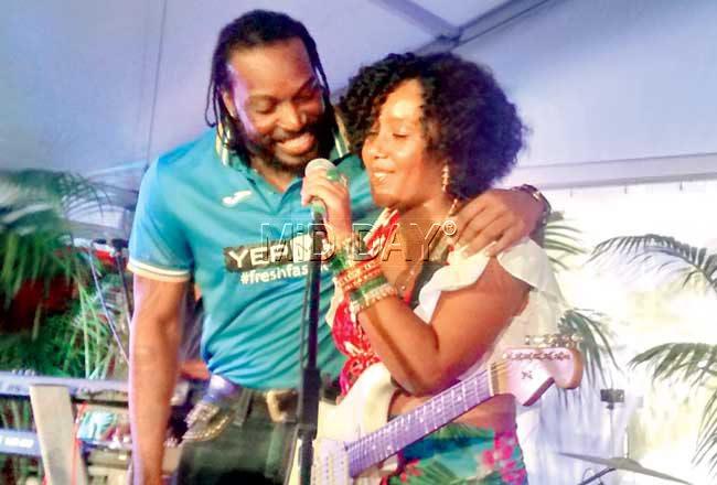 Chris Gayle joins an artist from an Australia-based Caribbean band on stage at the James Street Amphitheatre. Pics/Ashwin Ferro