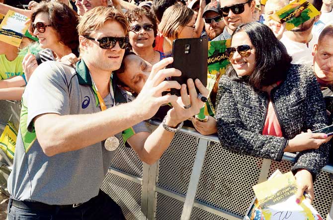 Shane Watson takes a selfie with a fan at Federation Square in Melbourne yesterday. Pic/AFP