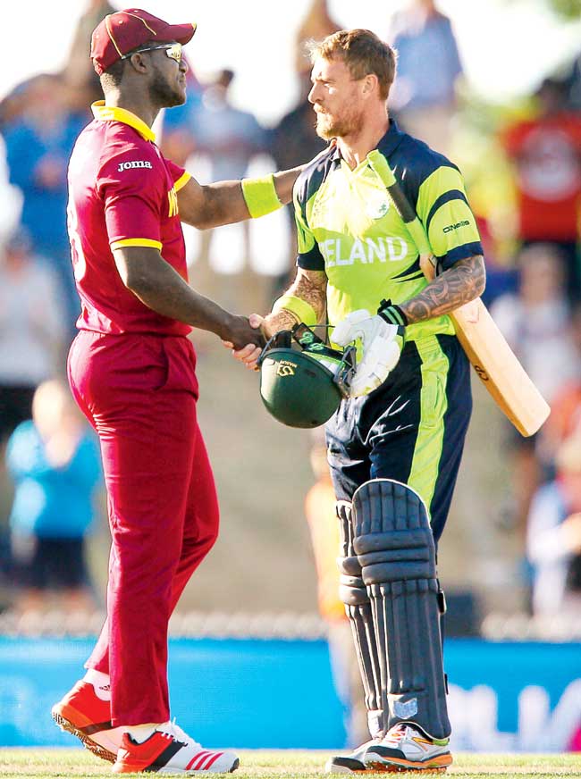 John Mooney (right) shakes hands with West Indies