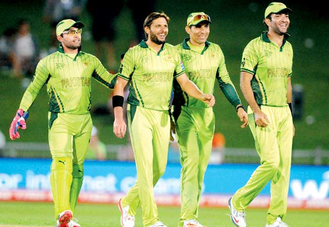 Pakistan players celebrate a UAE wicket yesterday. Pic/AP/PTI