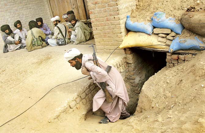 A Bugti guerrilla walking out of a bunker under construction in Dera Bugti, Balochistan. Successive Pakistani regimes have kept Balochistan subjugated, deprived and isolated. File Pic/Getty Images