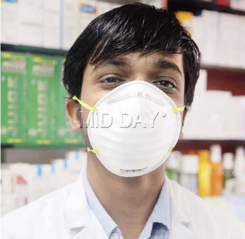 A chemist wears an N95 mask, which, according to experts, is better suited to prevent the spread of swine flu than regular masks. Pic/Nimesh Dave