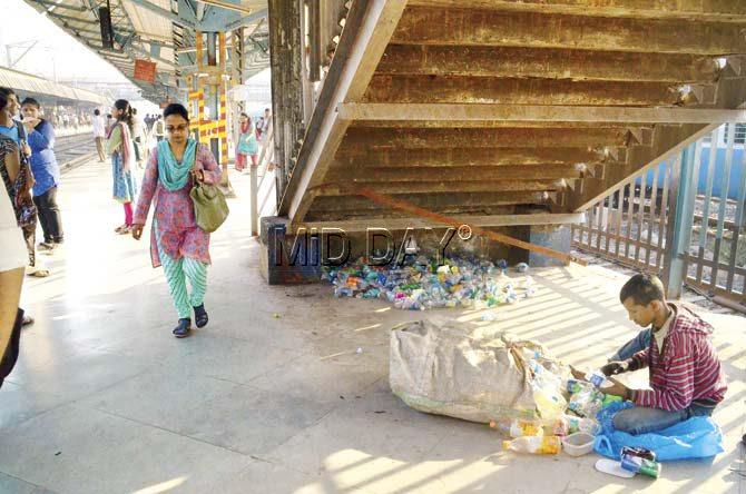 Or rather, platform, for this gleaner and his stock of discarded plastic ware. Pic/Shrikant Khuperkar