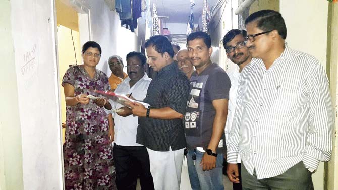 Laxman Gangan (third from right) and others collect money for the affected families