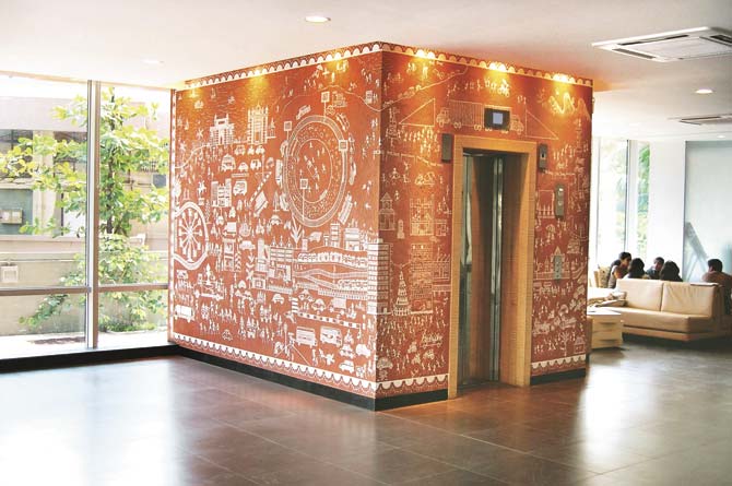 The lift with Warli art illustration at the reception