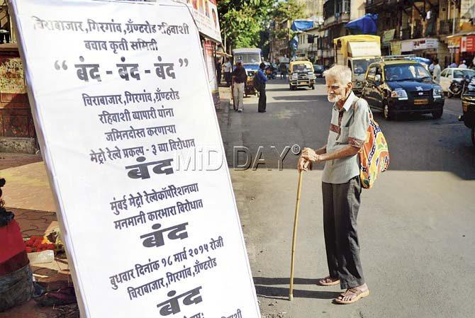 A senior citizen looks at an announcement of the protest to be held today against the Metro. Pics/Bipin Kokate