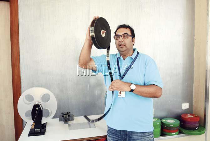 Shivendra Singh Dungarpur checks a negative at the spooling table inside the Films Division building at Pedder Road