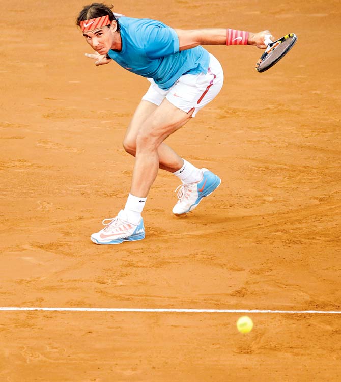 Rafael Nadal returns to Andy Murray during the Madrid Open final on Sunday. Pic/AFP