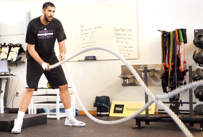 Sim Bhullar seen here at the Sacramento Kings practice facility in Sacramento, California, alternates his fitness regime between Battle Rope exercise