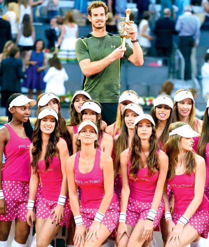 Andy Murray poses with ball girls & his Madrid Open trophy
