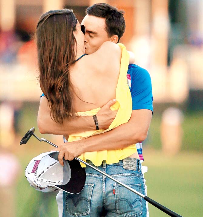 Rickie Fowler celebrates with girlfriend Alexis Randock after winning the final round of The Players Championship during a play-off at the TPC Sawgrass Stadium course on Sunday. Pic/AFP