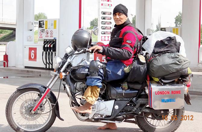 FUEL’S PARADISE: Subhash Inamdar at a petrol station with his 220cc Bajaj Avenger, which he will ride in the USA