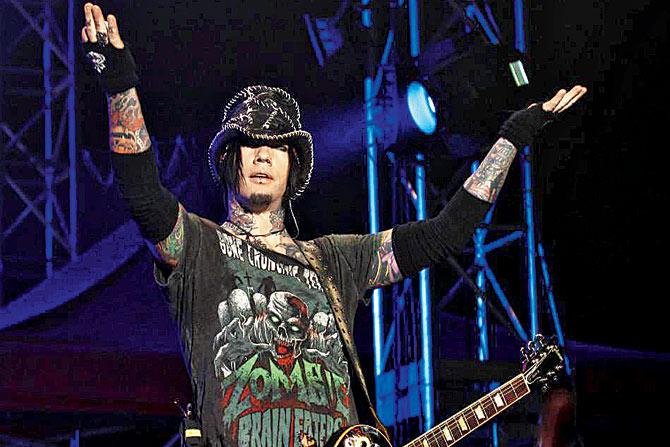  Guns N’ Roses guitarist DJ Ashba reacts to the crowd at a concert.  pic/Ap