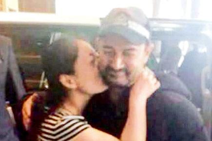 A fan kisses Aamir Khan during his visit to China