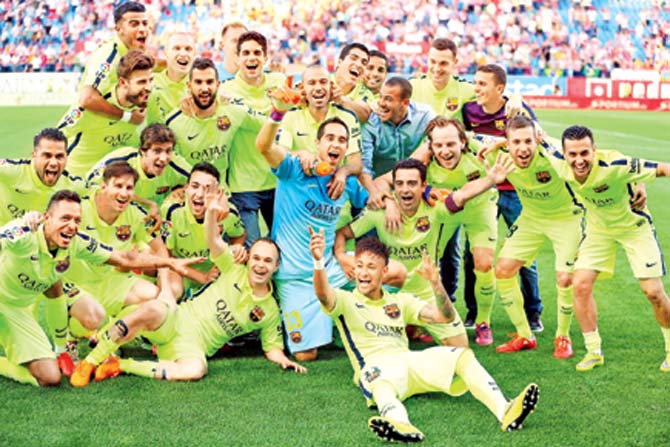 Barcelona players celebrate winning the La Liga championship after beating  Atletico Madrid at the Vicente Calderon Stadium on Sunday. Pic/AFP