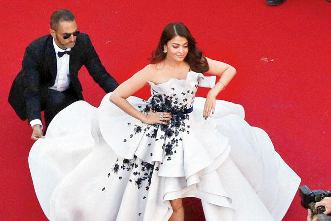 Aishwarya Rai Bachchan gets a helping hand on the red carpet at the Cannes film festival. PIC/ PTI