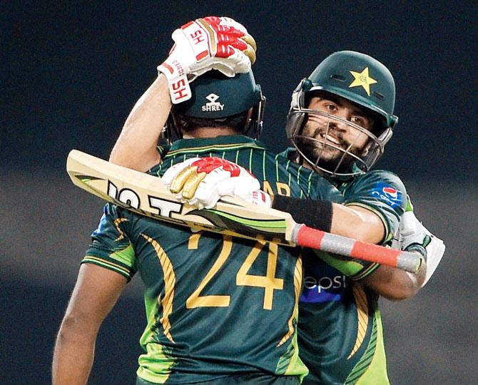 Mukhtar Ahmed is congratulated by Ahmed Shehzad (right) after scoring a 50 vs Zimbabwe yesterday. PIC/AFP