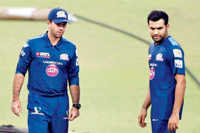 Mumbai Indians head coach Ricky Ponting (left) and skipper Rohit Sharma inspect the Eden Gardens pitch on the eve of their IPL final on Saturday. Pic/PTI