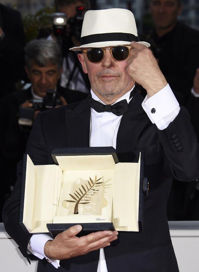 French director Jacques Audiard poses with his prize during a photocall after he was awarded with the Palme d