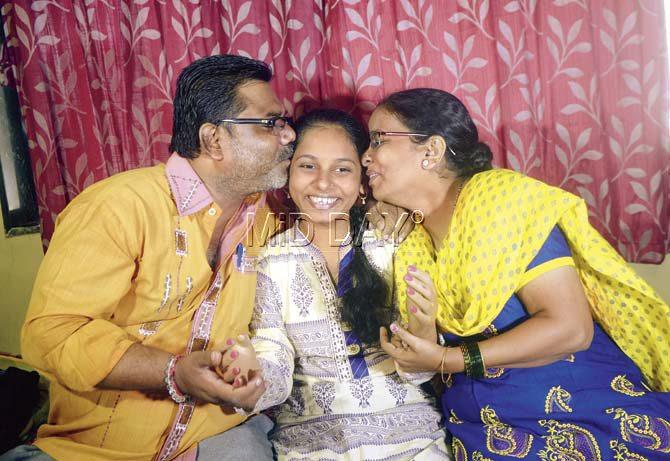 Monica, who had lost her arms in a train accident in January last year, celebrates her success with her family in Kurla. Pic/Pradeep Dhivar