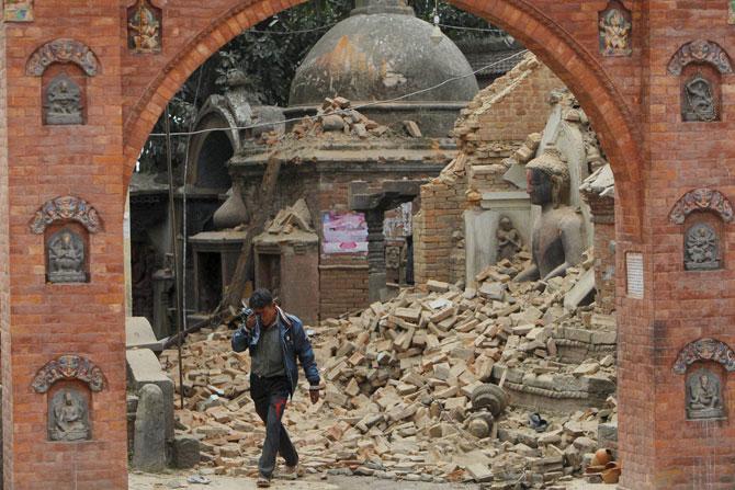 A Nepalese man cries as he walks through the earthquake debris in Bhaktapur, near Kathmandu, Nepal