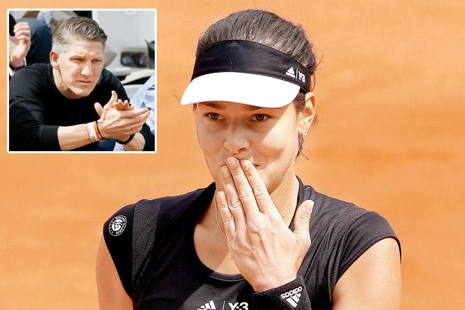 Serbian Ana Ivanovic blows kisses to the crowd after her French Open third round win over Croatia’s Donna Vekic even as Germany footballler Bastian Schweinsteiger (inset) applauds from the stands
