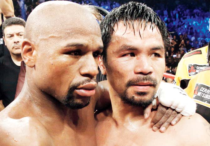 Floyd Mayweather Jr hugs Manny Pacquiao (right) after defeating Manny Pacquiao in their welterweight unification bout on May 2 at the MGM Grand Garden Arena in Las Vegas. Pic/AFP 