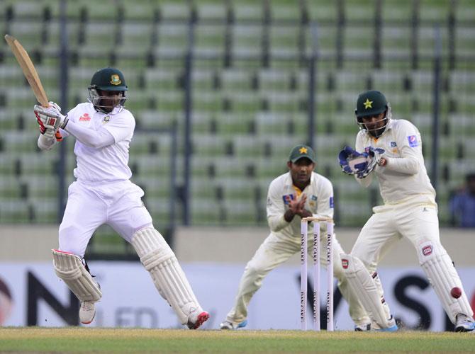 Bangladesh cricketer Shakib Al Hasan (L) plays a shot as Pakistan wicketkeeper Sarfraz Ahmed (R) looks on during the second day of the second cricket Test match between Bangladesh and Pakistan at the Sher-e-Bangla National Cricket Stadium in Dhaka on May 7, 2015. Pic/AFP