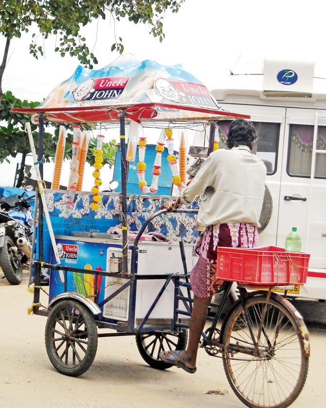 An ice cream vendor does brisk business by the waterfront in Fort Kochi