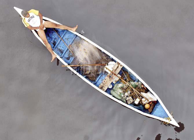A fisherman takes a quick nap on his fishing boat in the Arabian Sea near Bandra. Pic/Shadab Khan