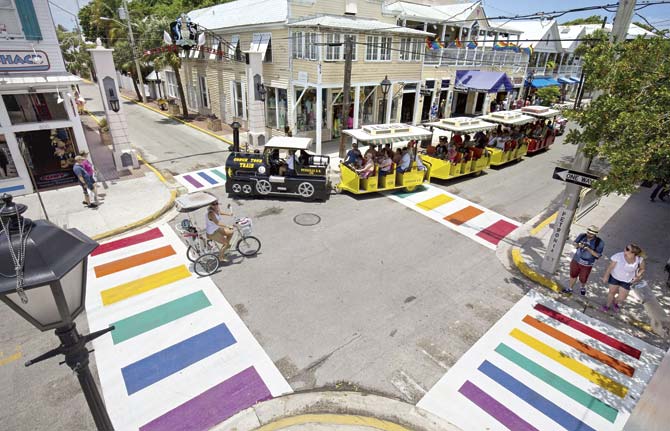 A Conch Tour Train turns at Duval and Petronia streets on May 28, in Key West, Florida. Spanning all four corners of the intersection, the crosswalks are internationally recognised symbols of gay and lesbian unity and are a permanent part of the pavement. Pic/AFP