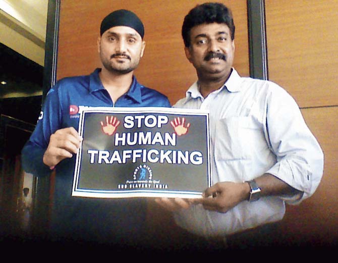 Mumbai indians’ off-spinner Harbhajan Singh with Anson Thomas and the anti-human trafficking sign at a city hotel on Tuesday