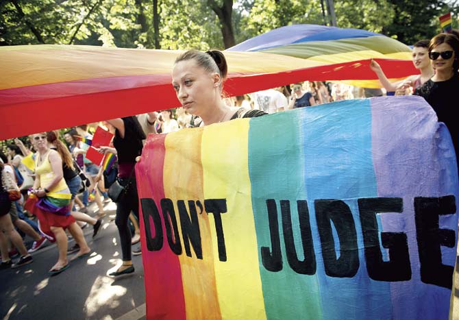 A participant walks with a banner reading ‘Don’t judge’ as she takes part in the Gay Pride March in Bucharest recently. This year, the Romanian LGBT community celebrated the 10th anniversary of the first Pride March