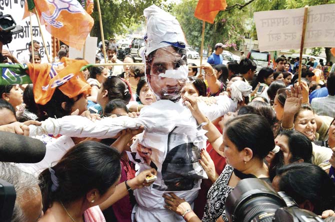 Activists of BJP Mahila Morcha burn an effigy of Aam Aadmi Party (AAP) leader Kumar Vishwas (who is currently embroiled in a scandal over an alleged extra-marital affair) during a protest at Delhi Chief Minister Arvind Kejriwal’s residence in New Delhi on Tuesday.  Pic/PTI
