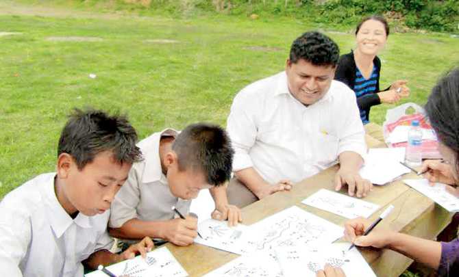 A city teacher conducts an art class, with a focus on Warli art