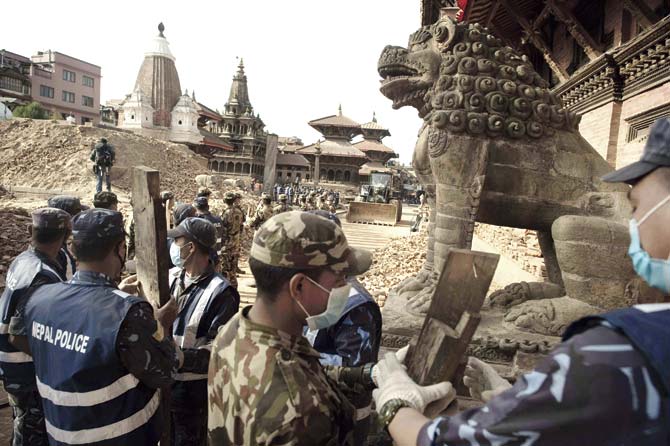 Nepalese soldiers line up to clear rubble from temples at the Patan Durbar square in Kathmandu yesterday. Nearly all of Nepal’s magnificent antiquities bearing testimony to its unique culture and harking back to its history now lie in ruins a clutter of stones, bricks and wooden beams. Pic/AFP