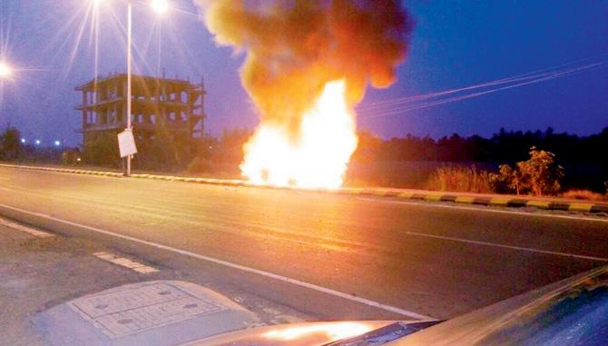 The BMW burns after villagers set it afire