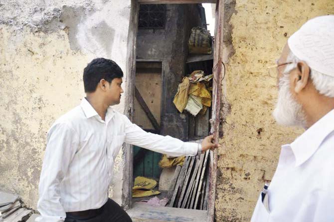 A local resident shows the spot at the cement shop where Habib Khan committed suicide