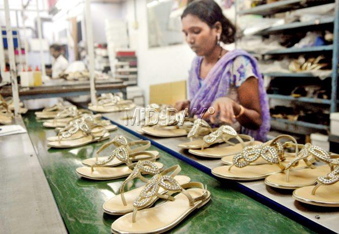 A worker checks each piece for dangling threads, missing embellishments etc  in the finishing process