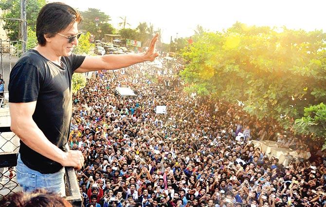 Sea of fans: Shah Rukh Khan waves out to his fans gathered outside Mannat on his birthday
