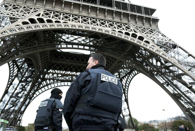 Police forces on patrol pass under the closed Eiffel Tower in Paris, France. Pic/PTI