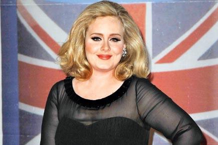 Singer Adele struggles to resist fame