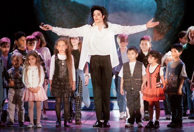 US pop star Michael Jackson sings with children on stage during the eighth World Music Awards ceremony in Monaco on May 9, 1996. Pic/AFP 