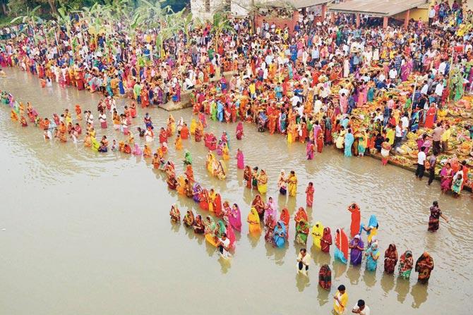 Devotees pray on the second day of Chhath Puja yesterday. Pic/PTI