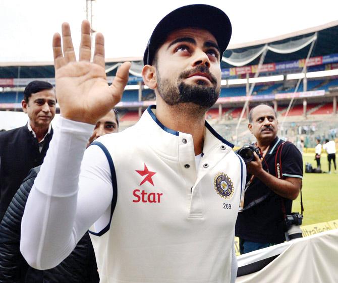  RIGHT:  Virat Kohli acknowledges the crowd after the match was called off due to bad weather at Chinnaswamy Stadium in Bangalore yesterday.