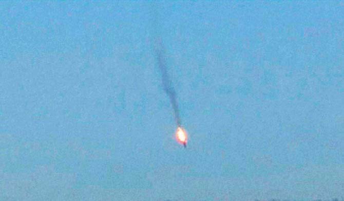 A TV video grab shows the Russian jet on fire before crashing on a hill