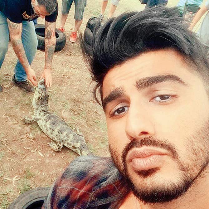 Arjun Kapoor gives us the 101 on pouting, amidst the wildlife and chaos behind him