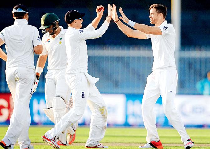 England pacer James Anderson (right) celebrates the wicket of Pakistan skipper Misbah-ul-Haq on Day One in Sharjah yesterday. Pic/Getty Images