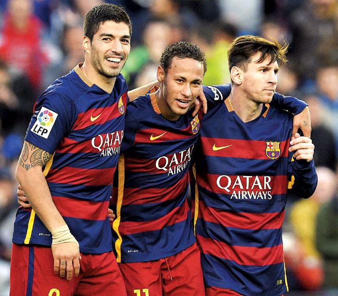 Luis Suarez (left), Neymar and Lionel Messi (right) celebrate after Barcelona