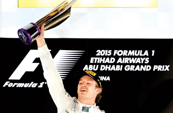 German driver Nico Rosberg celebrates on the podium at the Yas Marina circuit in Abu Dhabi yesterday. Pic/AFP